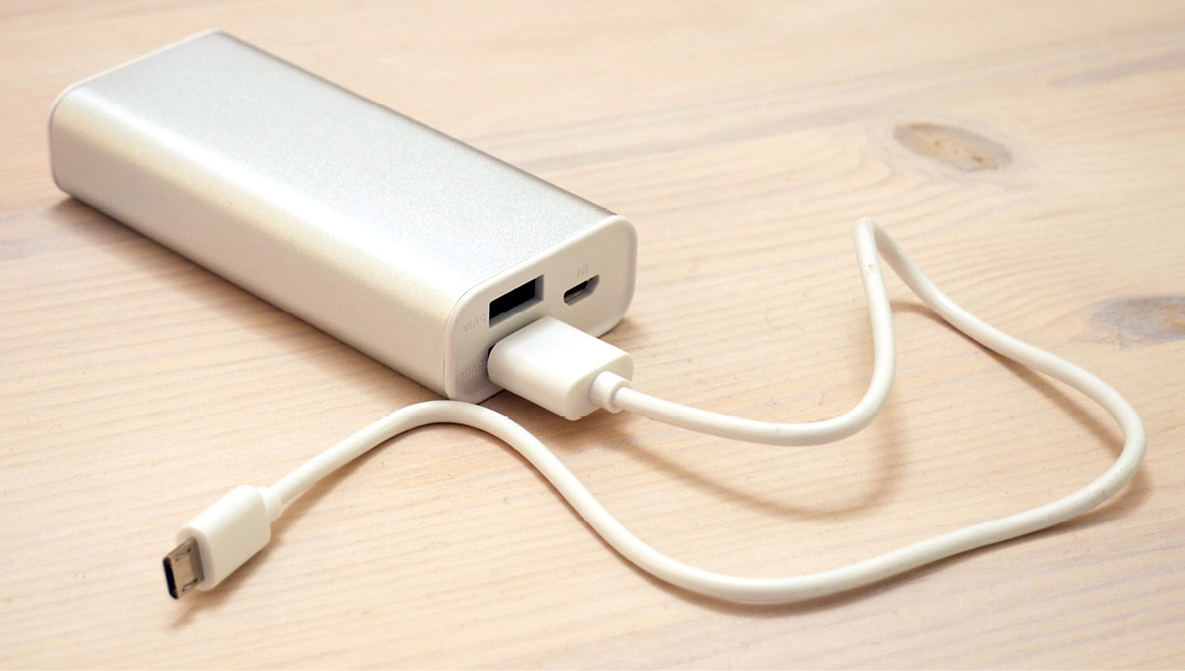 Figure 1.7 – A power bank with a micro USB cable attached (courtesy: https://commons.wikimedia.org/wiki/File:Portable_power_bank.jpg)
